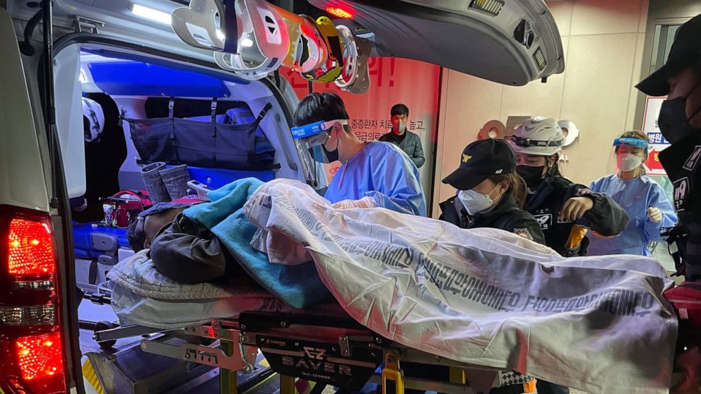 A miner rescued from a collapsed mine is carried into a hospital in Bonghwa, South Korea, Saturday, Nov. 5, 2022. Two South Korean miners rescued after being trapped underground for nine days said they had lived on instant coffee powder and water fal