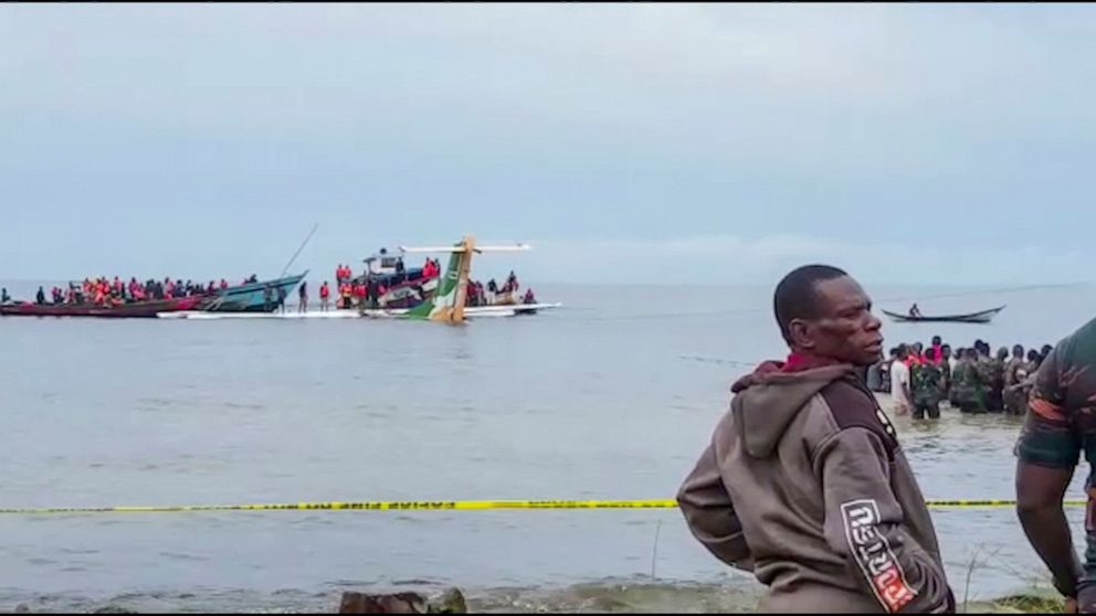 Rescuers in boats are seen around the tail fin of a crashed Precision Air passenger aircraft on the shores of Lake Victoria in Bukoba, in western Tanzania Sunday, Nov. 6, 2022. The small passenger plane crashed Sunday morning into Lake Victoria near 