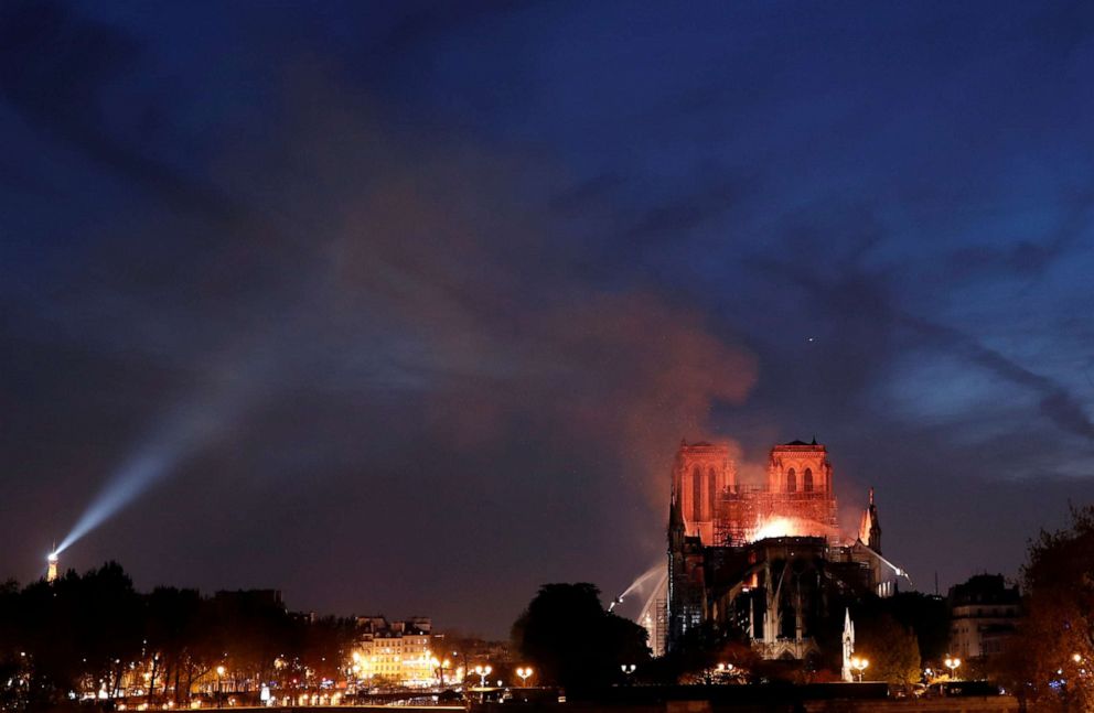  Fire fighters douse flames of the burning Notre Dame Cathedral in Paris, April 15, 2019.