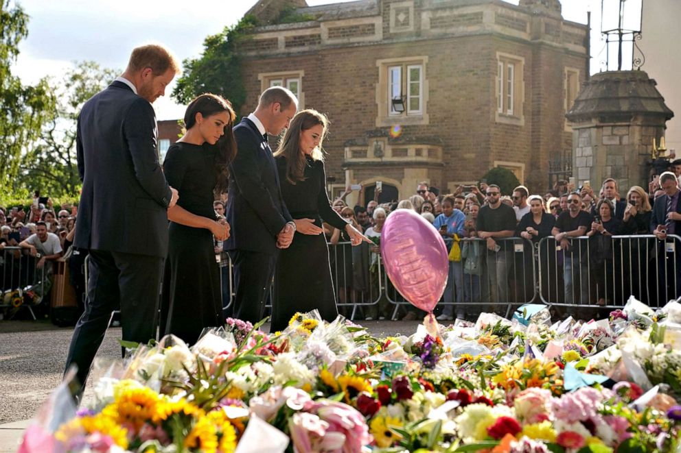 PHOTO: Prince Harry, Duke of Sussex, left, his wife Meghan, Duchess of Sussex, William, Prince of Wales and his wife Catherine, Princess of Wales look at floral tributes laid by members of the public on the Long Walk at Windsor Castle on Sept. 10, 2022.