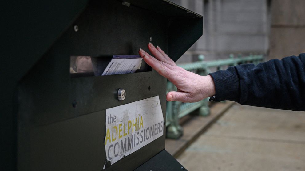 PHOTO: A voter casts their ballot at a drop box is displayed outside Philadelphia city hall on Oct. 24, 2022.