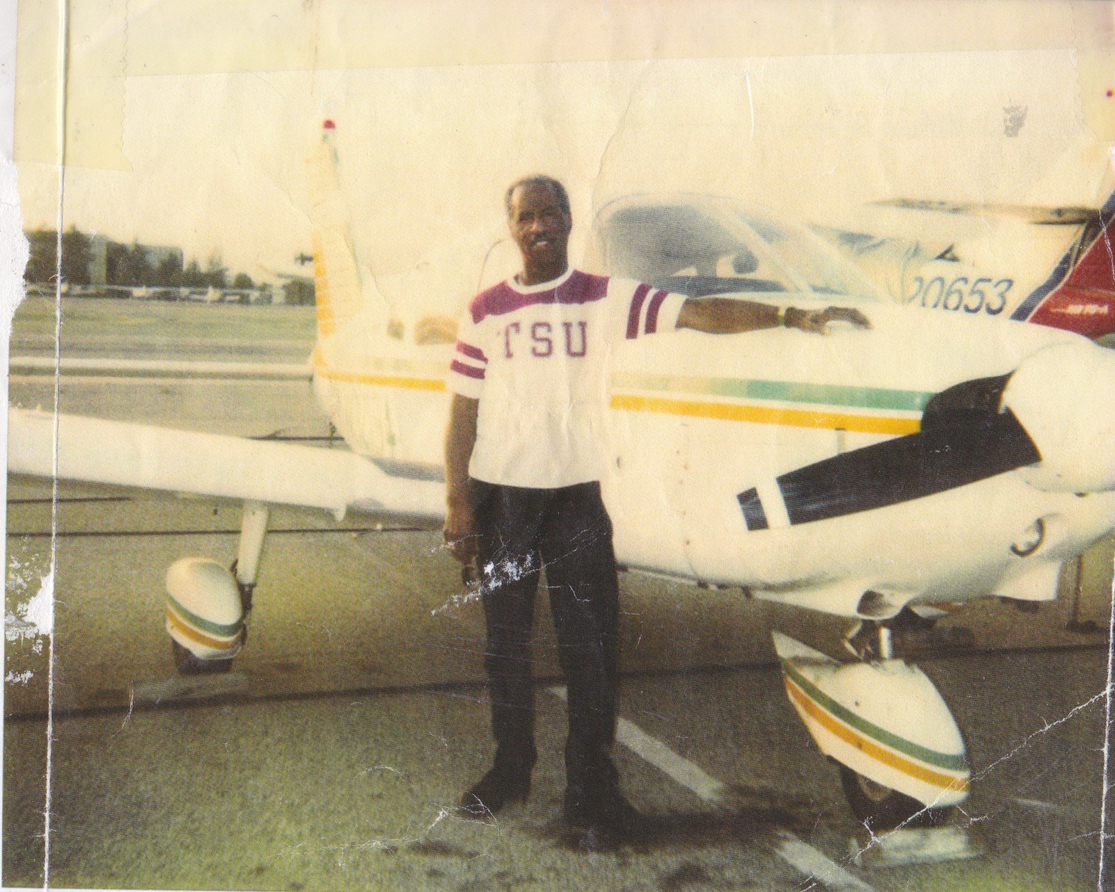 Don Bohana is seen here standing next to a plane in this undated family photo.