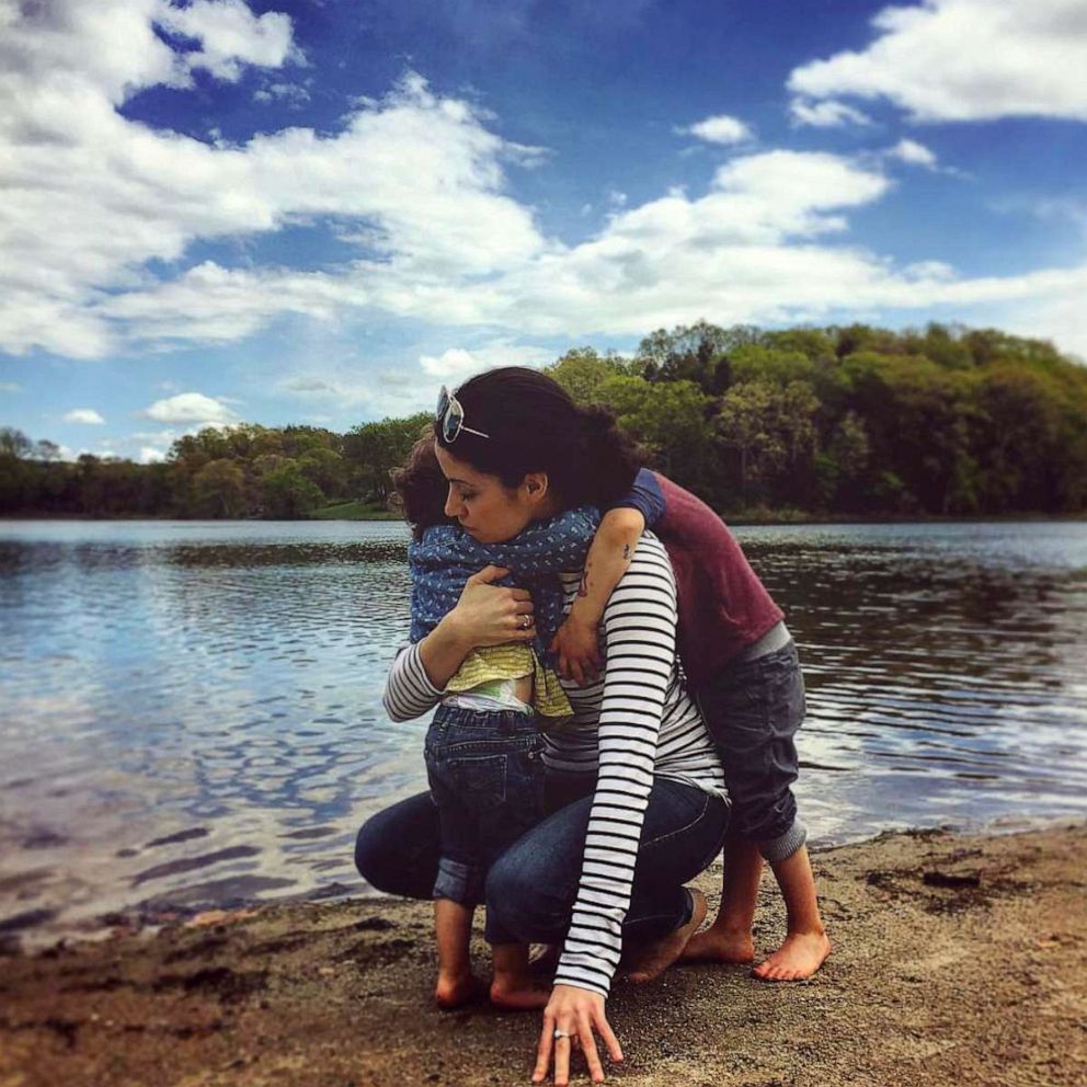 PHOTO: Nikki Addimando hugs her kids on a beach in May, 2017.