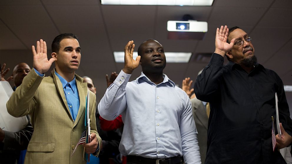 PHOTO: Newly naturalized American citizens take the Oath of Allegiance during a Naturalization Ceremony at the Jacob K. Javits Federal Building in New York, U.S., on Friday, April 19, 2013. 
