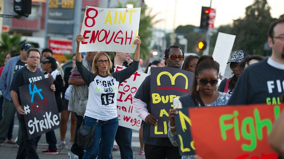 Fast food workers and their supporters picket outside a Burger King restaurant in Los Angeles on August 29, 2013. 