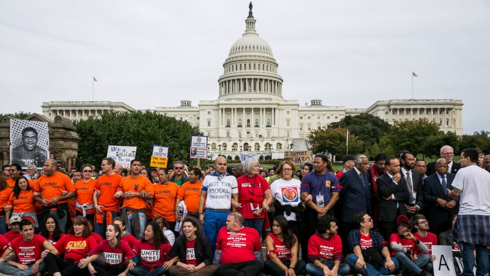 PHOTO: Supporters of immigration reform, along with several members of Congress, block First Street NW in front of the U.S. Capitol on October 8, 2013 in Washington, D.C.