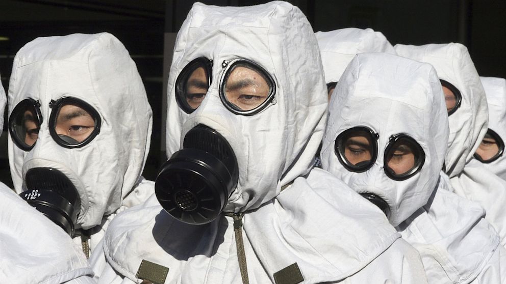 Men in chemical protection suits participate in a joint anti-terrorism drill conducted by Japan Ground Self-Defense Force on November 17, 2005.