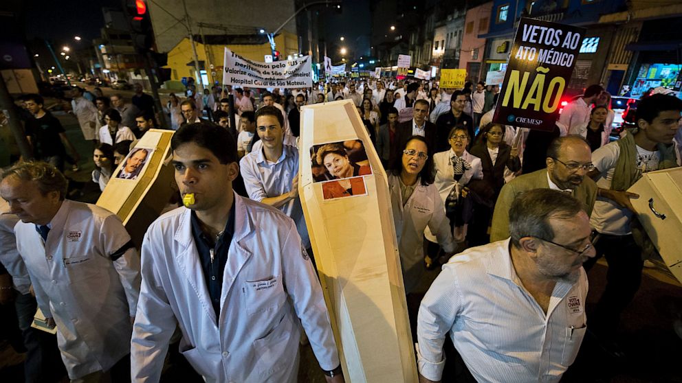 PHOTO: Doctors hold a coffin with the picture of Brazilian President Dilma Rousseff as they protest against the hiring of foreign medical doctors for Brazil's health care system, in Sao Paulo, on July 16, 2013.  