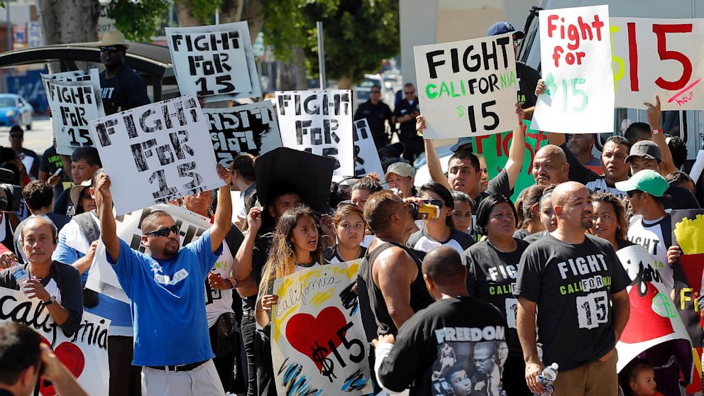 Thousands of fast-food workers and their supporters have been staging protests across the country to call attention to the struggles of living on or close to the federal minimum wage. The push raises questions about the economics of the minimum wage. (AP Photo/Nick Ut, File)