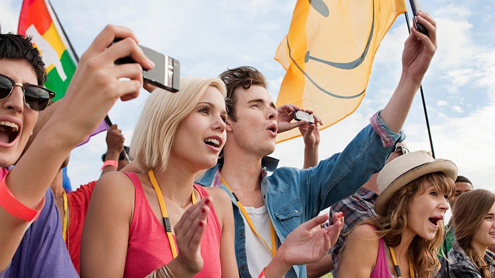 Millennials cheering at the Left Handers Day Parade because this is definitely not a royalty-free stock photo.