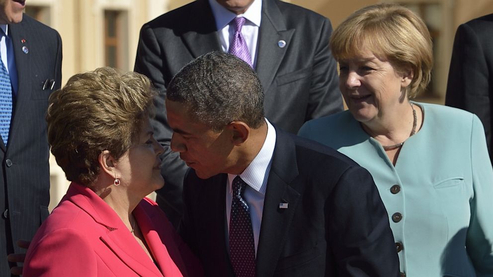 U.S. President Barack Obama gives a kiss 'hello' to Brazil's President Dilma Rousseff as they arrive for the family photo at the G20 summit on September 6, 2013 in Saint Petersburg. 