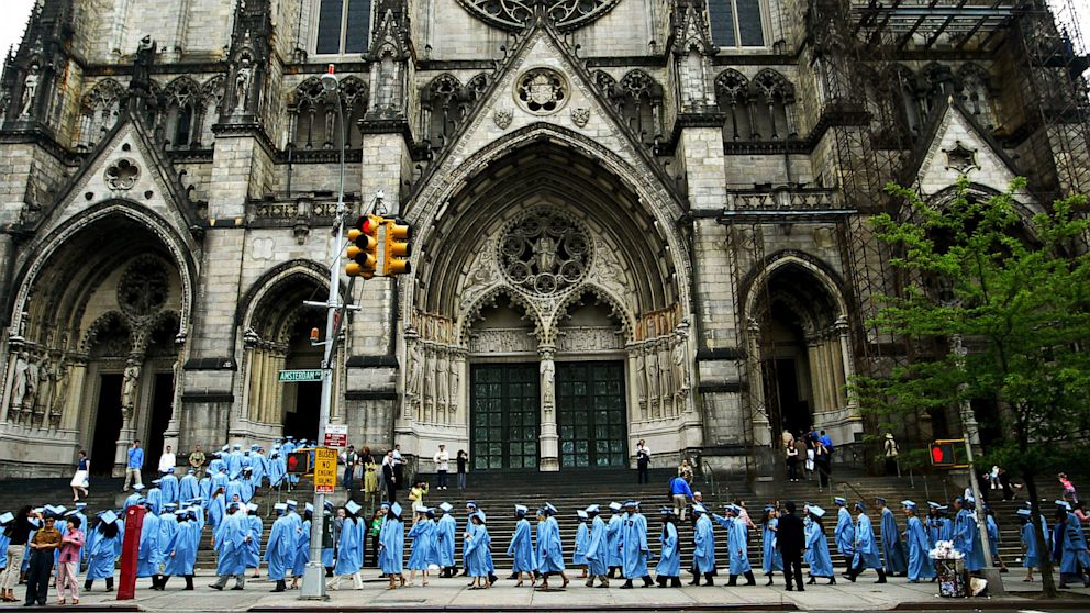 Graduates of Columbia University's lauded School of International and Public Affairs (SIPA) line up outside before SIPA's commencement exercises at St. John the Divine cathedral May 17, 2004 in New York City.