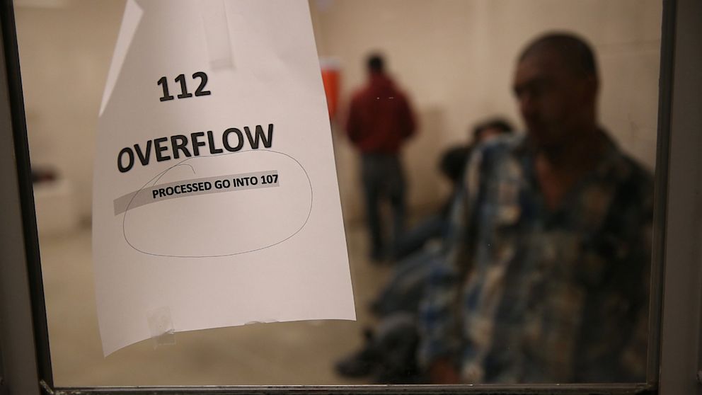 Male undocumented immigrants wait in a holding cell at the U.S. Border Patrol detainee processing center on April 11, 2013 in McAllen, Texas.