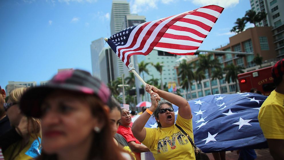 Maglena Gomez waves an American flag as she and others participate in a march that organizers said was an attempt to get the U.S. Congress to say yes to immigration reform on April 6, 2013 in Miami, Florida.