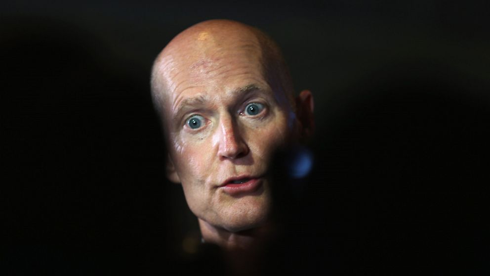 PHOTO: Florida Governor Rick Scott speaks with the media after holding a Florida Cabinet at the Miami-Dade College Wolfson Campus Auditorium on August 20, 2013 in Miami, Florida. 
