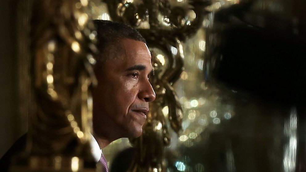 Seen in the reflection of a mirror, U.S. President Barack Obama pauses as he makes a statement on the Affordable Care Act during an East Room event May 10, 2013 at the White House in Washington, DC. President Obama spoke on impacts of the act on health, lives and pocketbooks of women and their families. 