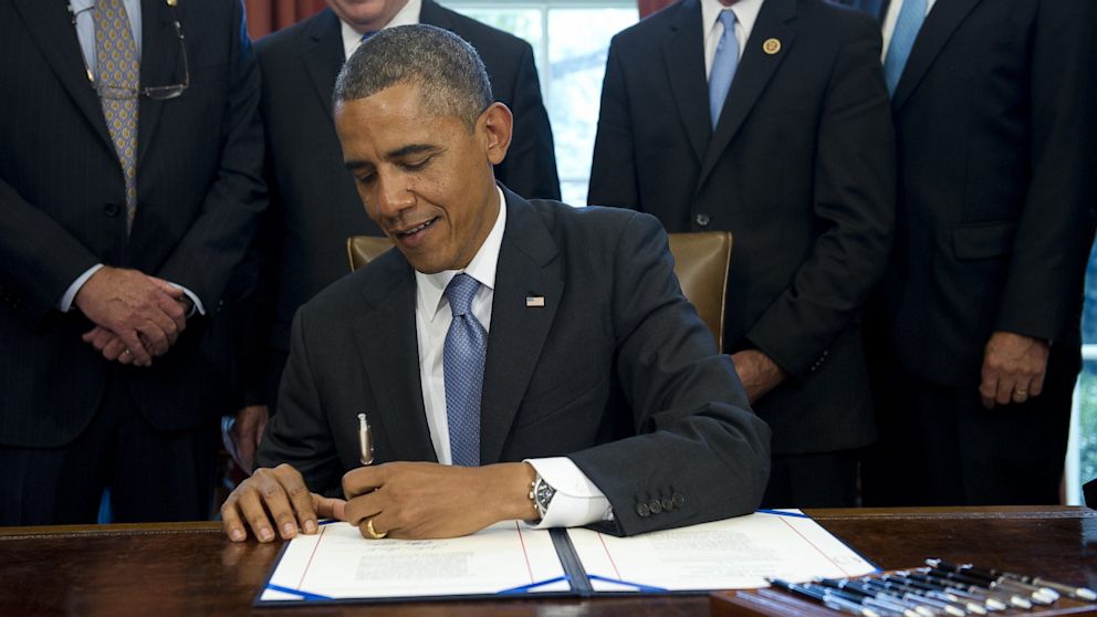US President Barack Obama signs a student loan bill to keep students' interest rates low during a signing ceremony in the Oval Office of the White House in Washington, DC, August 9, 2013. He will discuss college affordability during a bus tour of Pennsylvania and New York on August 22 and 23, 2013.