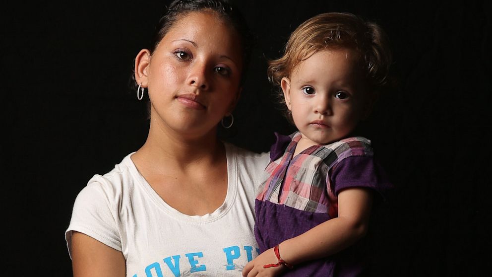 Salvadorian immigrant Stefanie Elizabeth, 17, holds her daughter Emily Nicole, 18 months, while spending another night at the Hermanos en el Camino immigrant shelter on August 5, 2013 in Ixtepec, Mexico. They planned to try to illegally cross into the United States.
