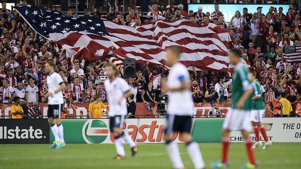 Fans unfurl a large U.S. flag after the U.S. Men's National Team scored their second goal against Mexico.