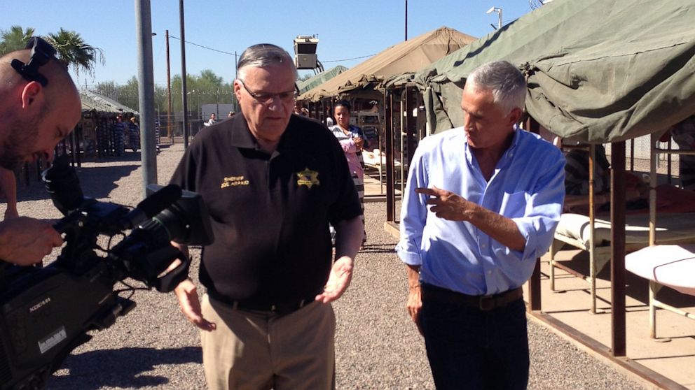 Fusion's Jorge Ramos (R) interviews Maricopa County Sheriff Joe Arpaio (L) during a tour of Tent City, a Phoenix jail.