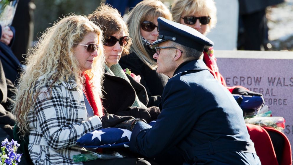 Maj. Gen. Steven Lepper, front right, consoles the family of U.S. Air Force Col. Francis McGouldrick Jr., from left, Marri Petrucci, Melisa Hill, Megan Genheimer, Michele Guess, as he hands each one of them an American flag during burial services at Arlington National Cemetery in Arlington, Va., Dec. 13, 2013. 