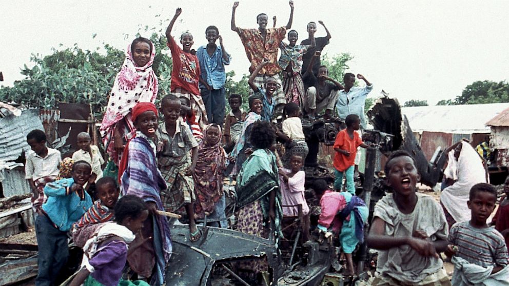 A group of young Somalis chant anti American slogans while sitting atop the burned out hulk of a U.S. Black Hawk helicopter in Mogadishu, Somalia on Oct. 19, 1993. The helicopter was one of two shot down during a firefight with Somali guerrillas in which 18 U.S. servicemen were killed along with one Malaysian peacekeeper and 300 Somalis.