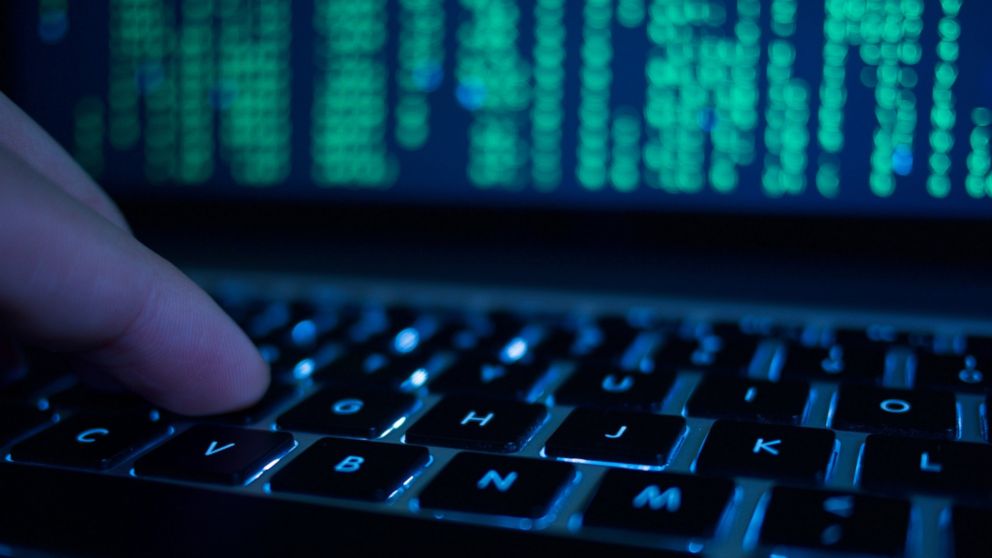A man at a computer is seen here in this undated file photo.