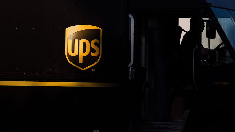 The silhouette of a driver is seen in a UPS delivery truck at the distribution center in Sacramento, Calif., Feb. 14, 2013.  