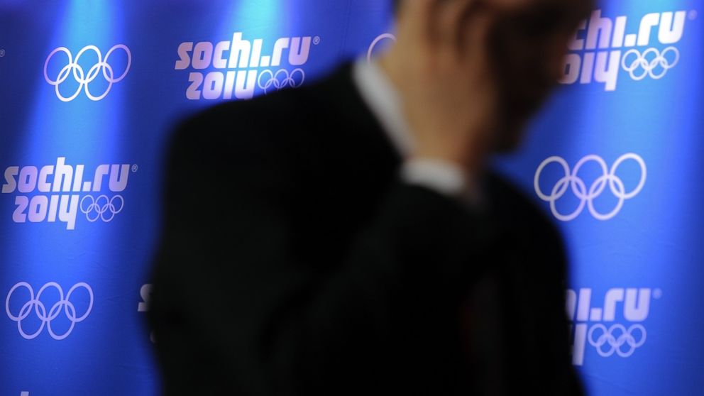 PHOTO: A man uses his mobile phone walking past logos of Sochi 2014 Olympics during a press conference, Feb. 14, 2012, in Krasnaya Polyana. 