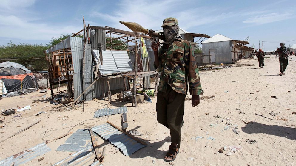 An Al-Shabaab soldier carries a rocket-propelled grenade as he patrols along the streets of Dayniile district in Southern Mogadishu, Somalia, March 5, 2012. 
