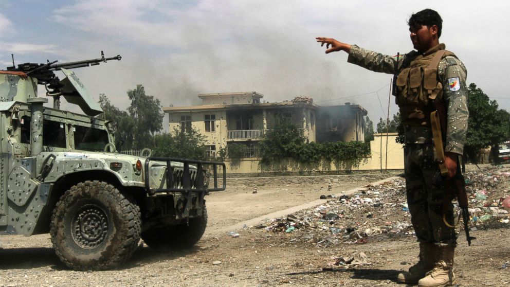 Afghan security forces arrive at the scene after Taliban fighters stormed a government building in Jalalabad province, May 12, 2014. 