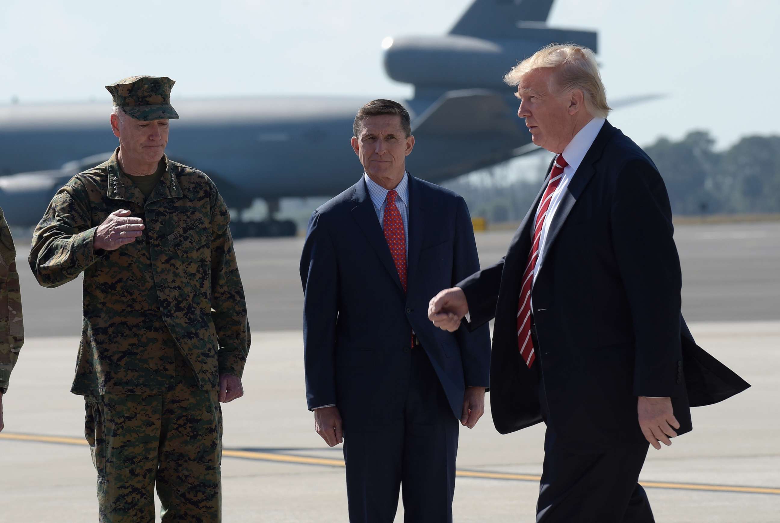 PHOTO: President Donald Trump walks in front of National Security Adviser Michael Flynn and Joint Chiefs Chairman Gen. Joseph Dunford, left, and after arriving at MacDill Air Force Base in Tampa, Fla., Feb. 6, 2017. 