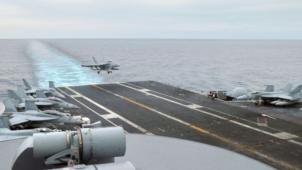 This photograph taken on October 24, 2013 in the South China Sea shows a US fighter jet making its landing on the USS George Washington aircraft carrier. 