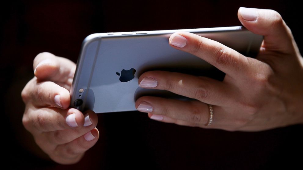 A member of the media inspects the new iPhone 6 during an Apple special event at the Flint Center for the Performing Arts on September 9, 2014 in Cupertino, Calif.