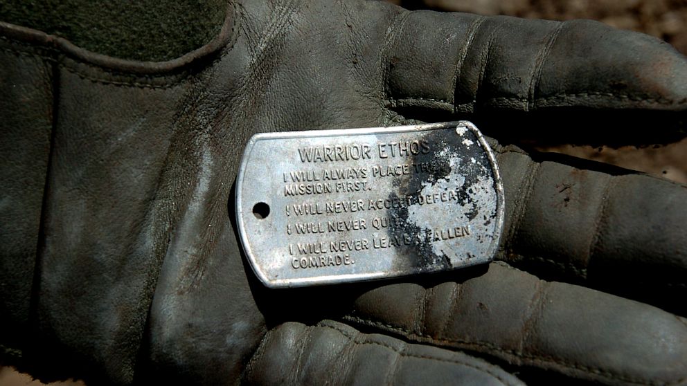 PHOTO: A dog tag with the "Warrior Ethos" inscribed on it, discovered in the wreckage of a shot down MH-47 helicopter in Operation Red Wings on June 28, 2005.
