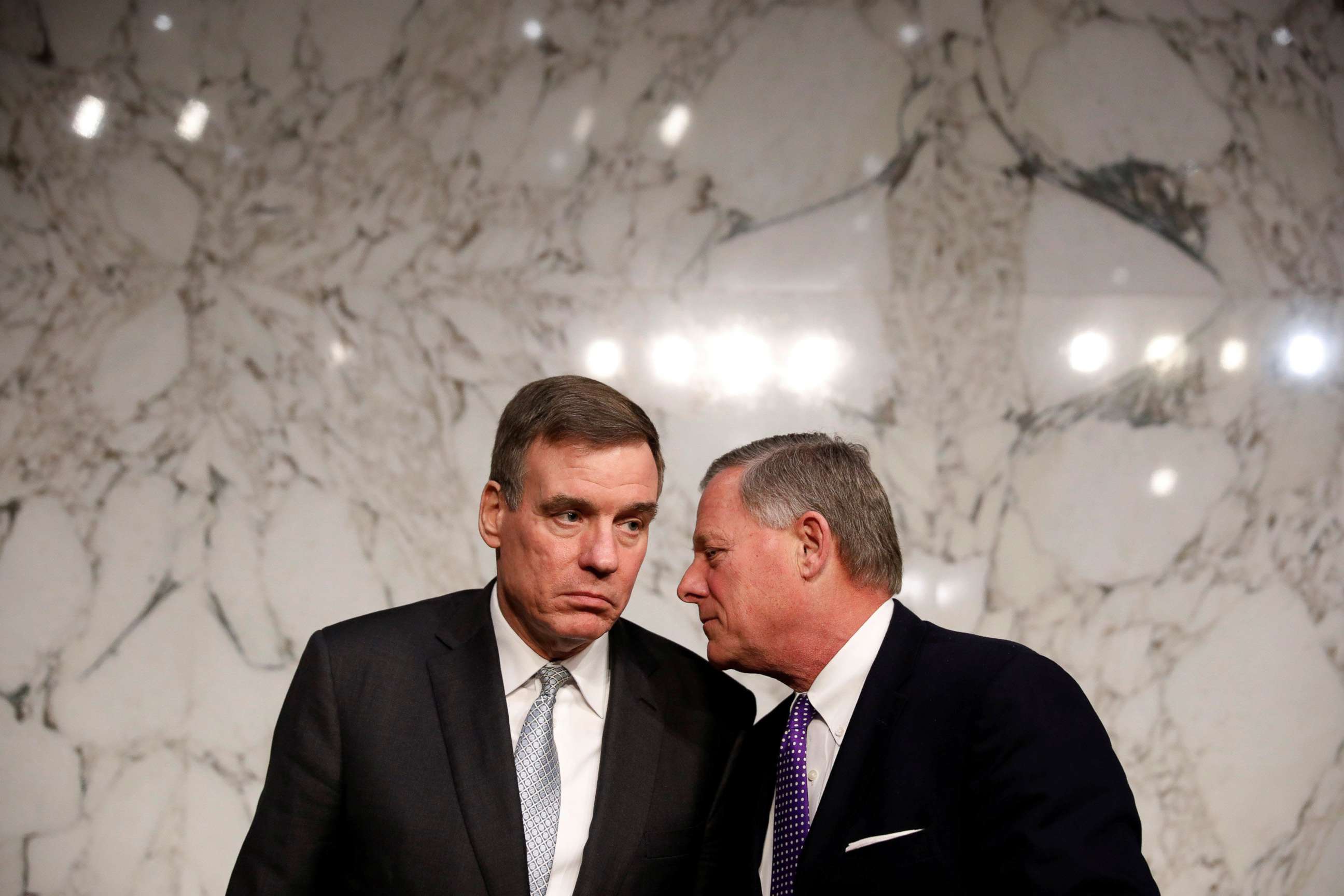 PHOTO: Sen. Mark Warner speaks with Sen. Richard Burr after a hearing of the Senate Intelligence Committee on Capitol Hill in Washington, Feb. 13, 2018.