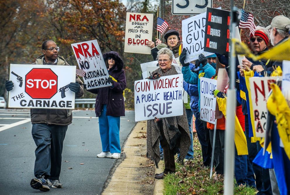 PHOTO: Demonstrators with the Virginia Gun Violence Prevention Coalition gather for their monthly protest/picket in front of NRA Headquarters to call for universal background checks and mourn those lost to gun violence, Nov., 14, 2015, in Fairfax, Va.