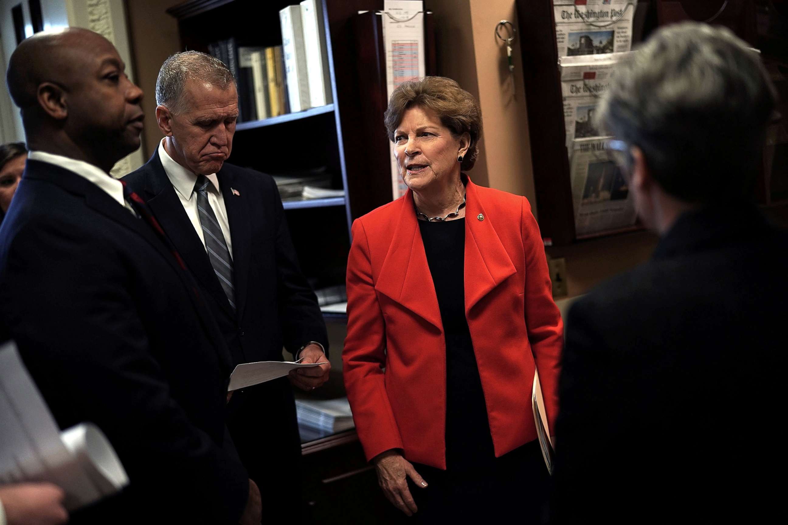 PHOTO: Sen. Jeanne Shaheen (D-NH) (R) talks to Sen. Thom Tillis (R-NC) (2nd L) and Sen. Tim Scott (R-SC) (L) prior to a news conference at the Capitol, Feb. 7, 2018. 