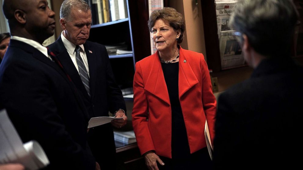 Sen. Jeanne Shaheen (D-NH) (R) talks to Sen. Thom Tillis (R-NC) (2nd L) and Sen. Tim Scott (R-SC) (L) prior to a news conference at the Capitol, Feb. 7, 2018.