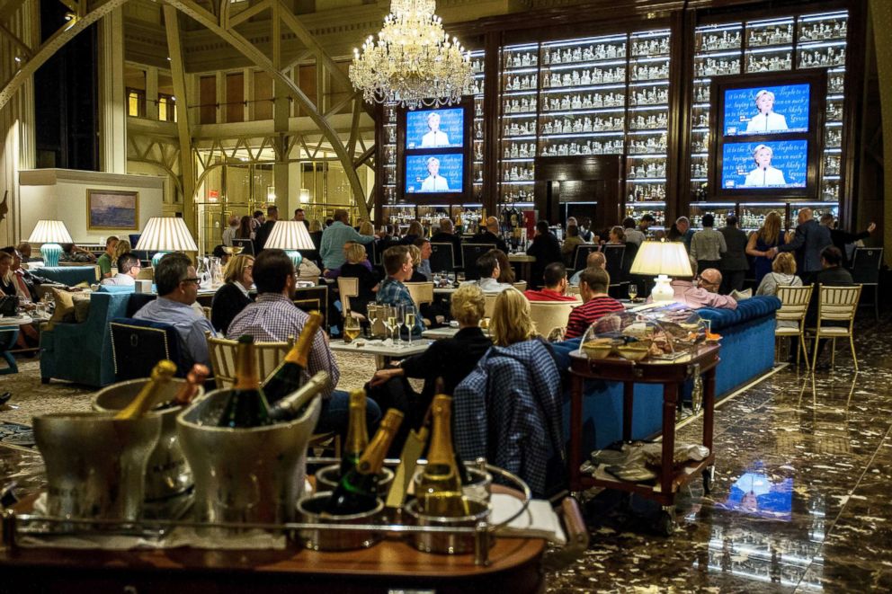 PHOTO: People watch the third presidential debate between Democratic presidential candidate Hillary Clinton and  Republican presidential candidate Donald Trump at the Trump International Hotel, Oct. 19, 2016, in Washington, D.C.