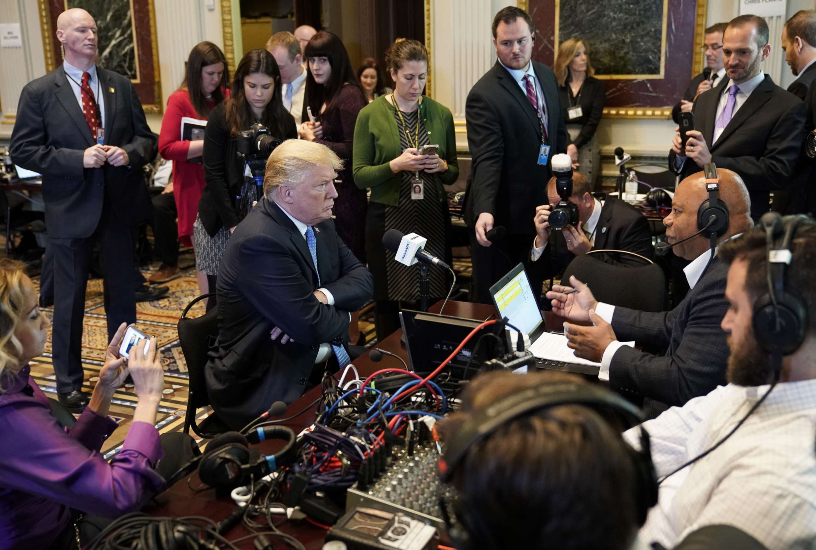 PHOTO: President Donald Trump looks at a reporter as he takes part in a series of radio interviews in the Eisenhower Executive Office Building, next to the White House, on Oct. 17, 2017 in Washington.