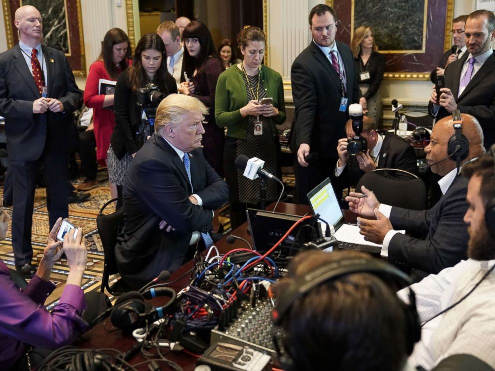 PHOTO: President Donald Trump looks at a reporter as he takes part in a series of radio interviews in the Eisenhower Executive Office Building, next to the White House, on Oct. 17, 2017 in Washington.