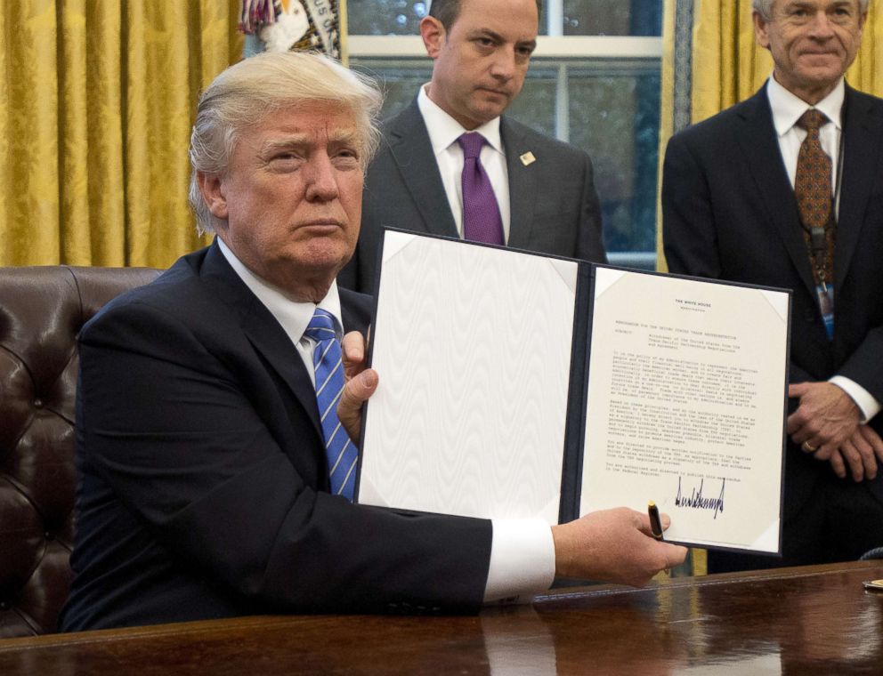 PHOTO: President Donald Trump holds an executive order titled "Mexico City Policy", which bans federal funds going to overseas organizations that perform abortions, Jan. 23, 2017.