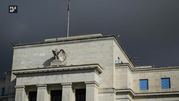 Fed holds interest rates steady, defying Trump
