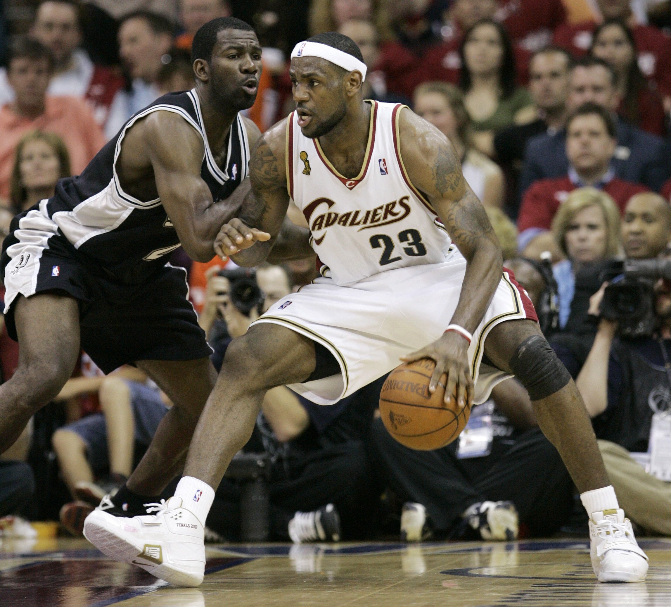 PHOTO: Cleveland Cavaliers' LeBron James drives past San Antonio Spurs' Michael Finley during the second quarter in Game 4 of the NBA basketball finals June 14, 2007, in Cleveland.  