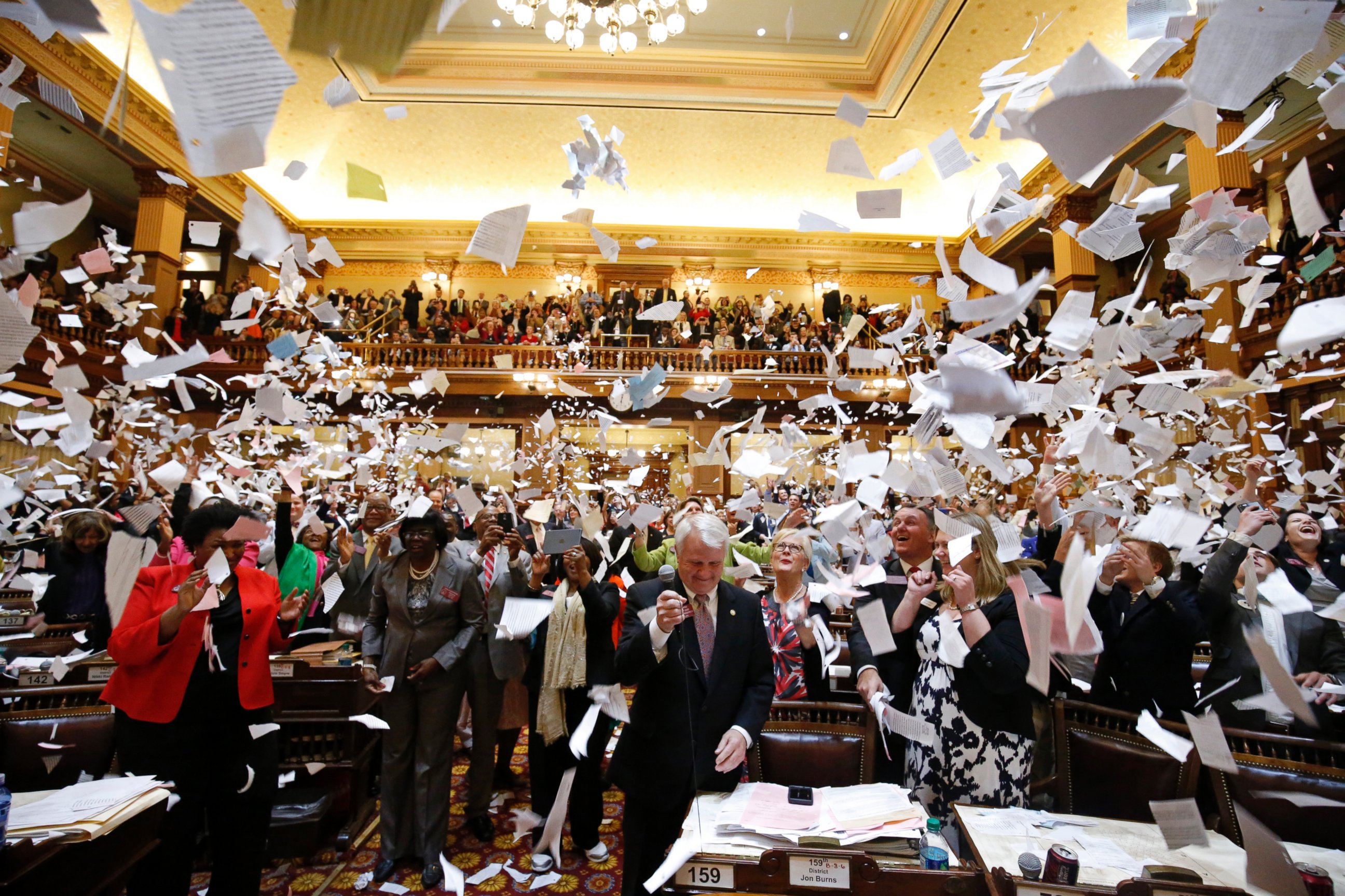 PHOTO: Representatives throw papers up in the air at the conclusion of the final day of the Georgia General Assembly at the capitol in Atlanta, March 25, 2016.