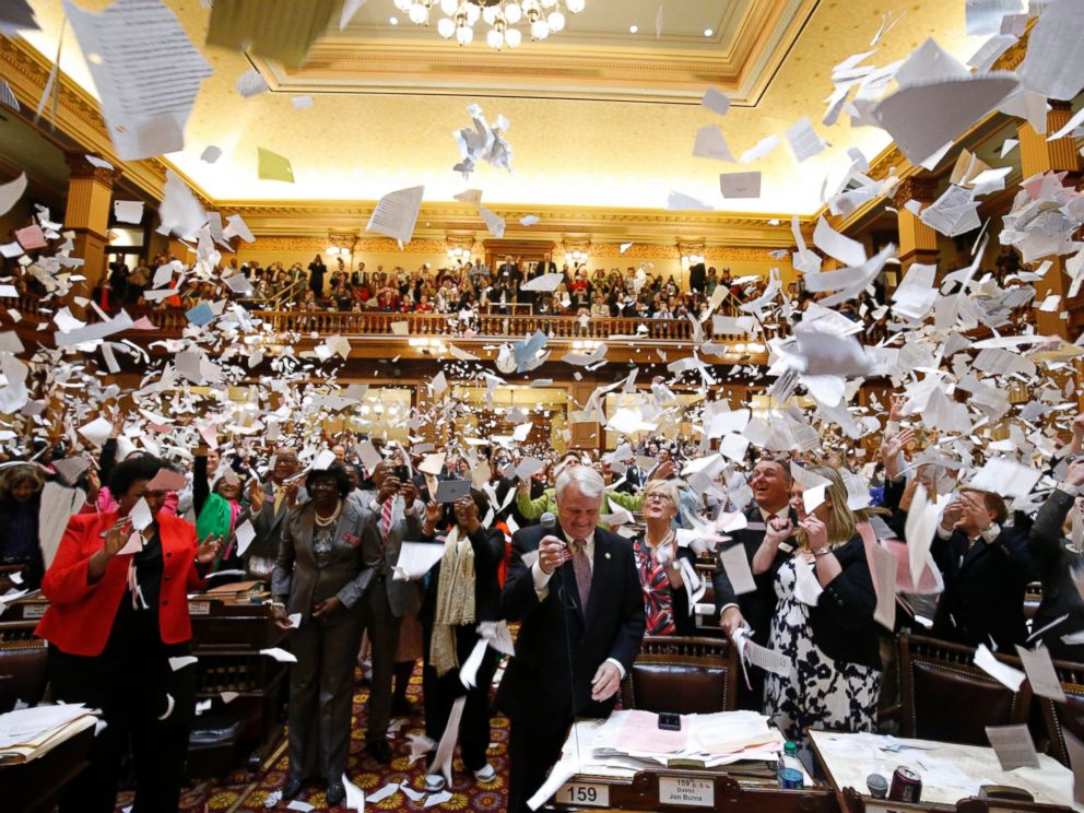 PHOTO: Representatives throw papers up in the air at the conclusion of the final day of the Georgia General Assembly at the capitol in Atlanta, March 25, 2016.