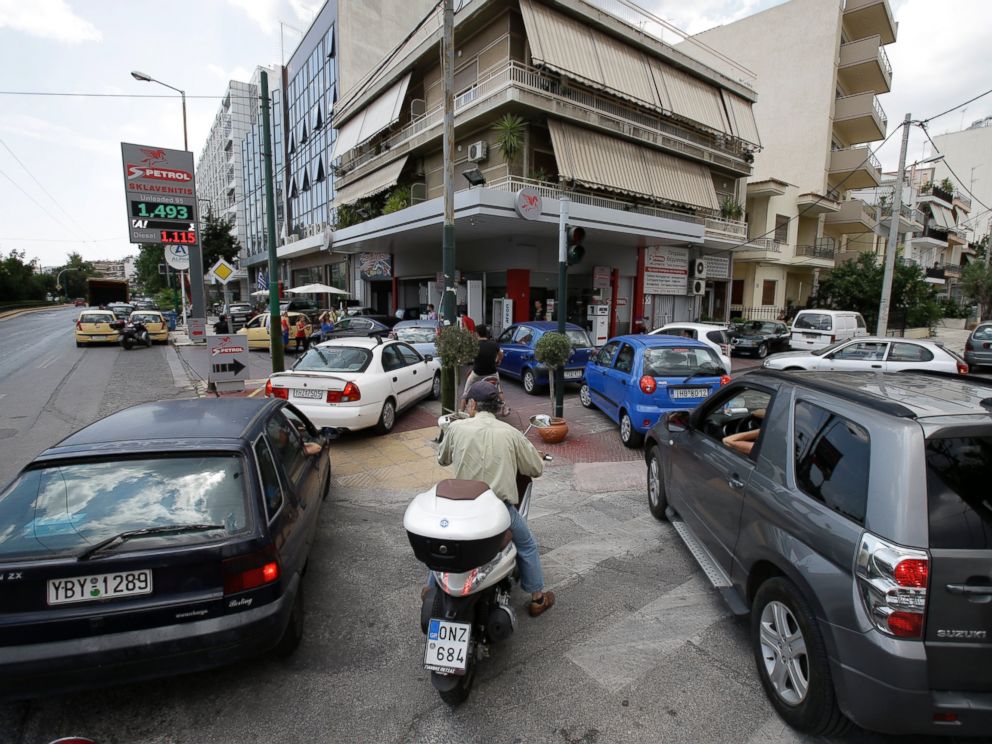 PHOTO: Drivers wait to fill their cars and scooters at a filling station, June 29, 2015, in Athens.