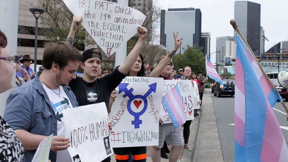 Demonstrators protesting passage of legislation limiting bathroom access for transgender people stand in front of the Charlotte-Mecklenburg Government Center in Charlotte, N.C., March 31, 2016. 