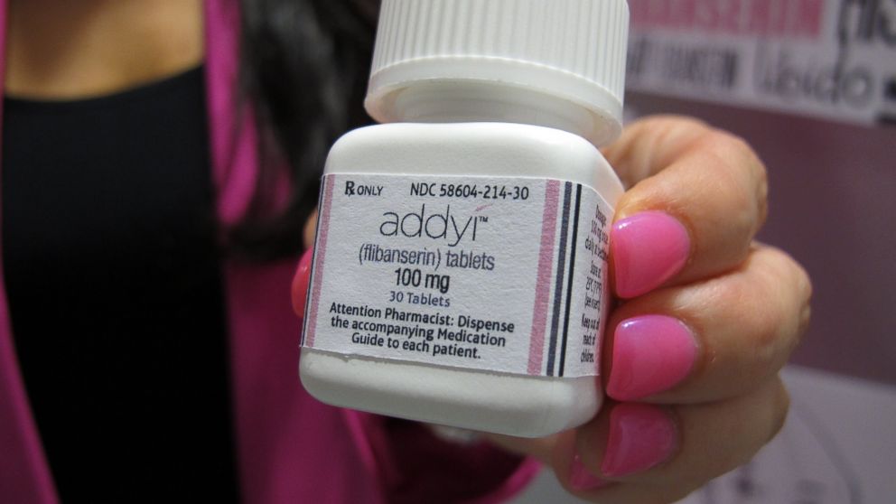 Sprout Pharmaceuticals CEO Cindy Whitehead holds a bottle for the female sex-drive drug Addyi, Aug.15, 2015, at her Raleigh, N.C., office.